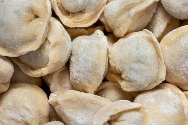 Dumplings with trout fillet. On a white background, in brown, cardboard packaging lie frozen trout fillets with finely chopped.