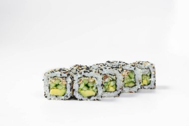 Sushi roll california in sesame with eel. Filled with eel, avocado and cucumber, wrapped in nori seaweed and rice with black and white sesame seeds. Sushi stands on a white background.