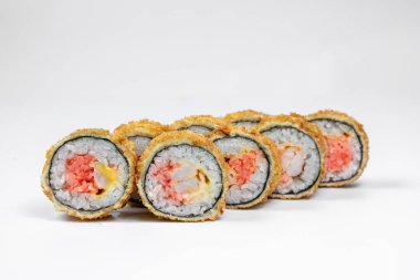 Hot sushi roll with crab meat. Snow crab meat filling, shrimp, Japanese mayonnaise, tobiko caviar, cheddar cheese, wrapped in rice, nori seaweed and fried tempura. Sushi stands on a white background.