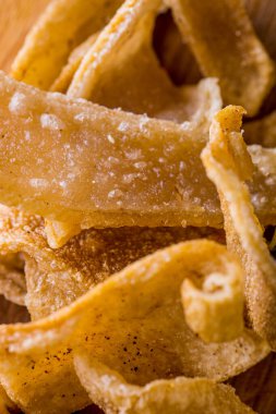 Corn chips on a wood board. Vertical orientation