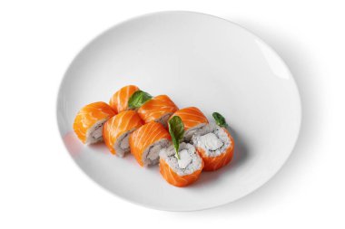 Roll with rice, basil, salmon and Philadelphia cheese on a white background