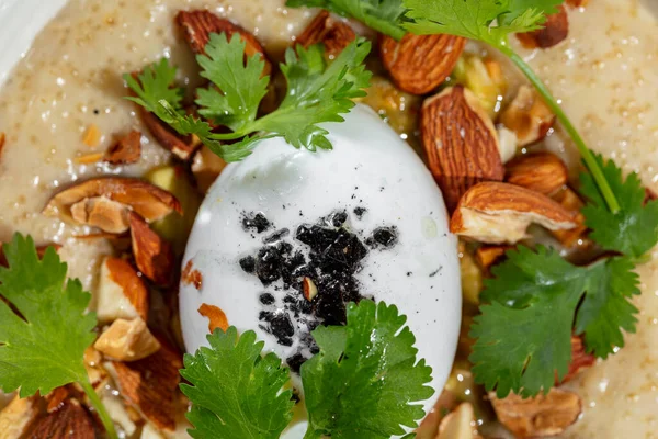 Breakfast Morning Dish Salted Oatmeal Almonds Poached Eggs Parsley Leaves — Stok fotoğraf