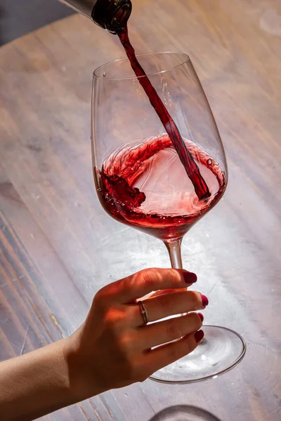 Girl Pours Wine Bottle Glass Background Table — Foto de Stock