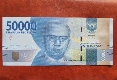 West Java on July 2022. Pile of rupiah notes with a nominal unit of fifty thousand.
