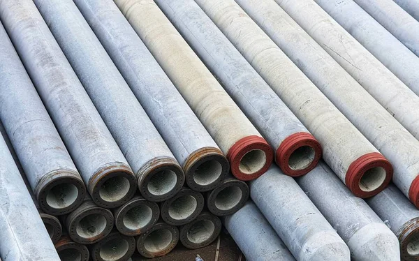 Pile of precast concrete spun pile in a construction project stockyard.