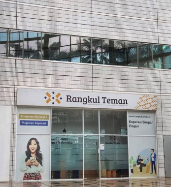 The inside of a tall building, lots of glass and very futuristic.