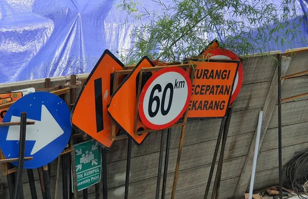 Construction signs that have been fabricated but not yet installed on the construction site. This sign has a striking color so that road users are aware if there is construction work going on.