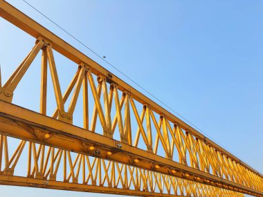 This is the steel structure of a launcher gantry that will be used for erection precast concrete I Girder (PCI Girder) across the river . This yellow gantry launcher comes from China with a capacity of up to 140 tons, with a maximum launch speed of 4