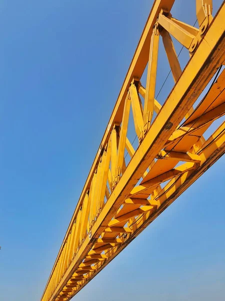 This is the steel structure of a launcher gantry that will be used for erection precast concrete I Girder (PCI Girder) across the river . This yellow gantry launcher comes from China with a capacity of up to 140 tons, with a maximum launch speed of 4