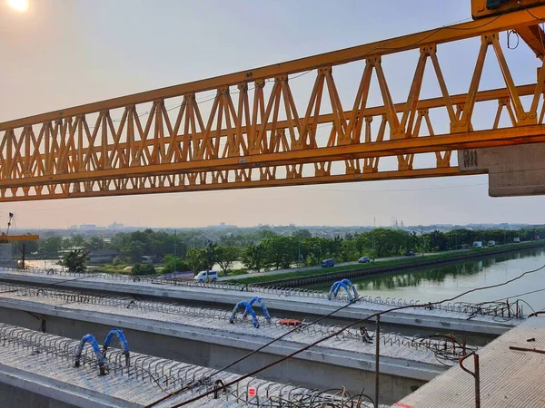 This is the steel structure of a launcher gantry that will be used for erection precast concrete I Girder (PCI Girder) across the river . This yellow gantry launcher comes from China with a capacity of up to 140 tons, with a maximum launch speed of 4