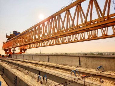 This is the steel structure of a launcher gantry that will be used for erection precast concrete I Girder (PCI Girder) across the river . This yellow gantry launcher comes from China with a capacity of up to 140 tons, with a maximum launch speed of 4
