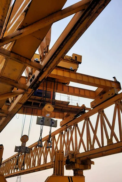 This is the steel structure of a launcher gantry that will be used for erection precast concrete I Girder (PCI Girder) across the river . This yellow gantry launcher comes from China with a capacity of up to 140 tons, with a maximum launch speed of 4
