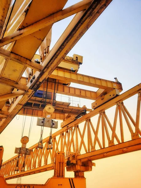 This is the steel structure of a launcher gantry that will be used for erection precast concrete I Girder (PCI Girder) across the river . This yellow gantry launcher comes from China with a capacity of up to 140 tons, with a maximum launch speed of 4