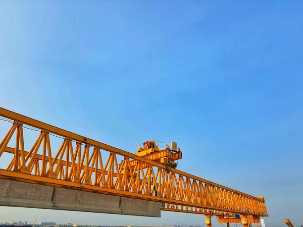 This is the steel structure of a launcher gantry that will be used for erection precast concrete I Girder (PCI Girder) across the river . This yellow gantry launcher comes from China with a capacity of up to 140 tons, with a maximum launch speed of 4