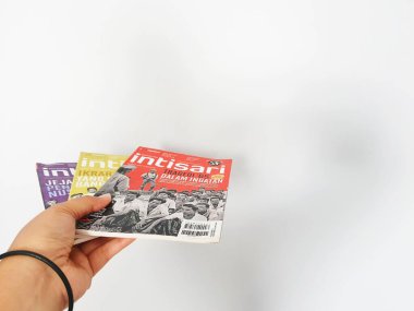 West Java, August 2022. A hand is holding some Intisari magazines. Intisari is the name of a monthly magazine that originated in Indonesia and was first published in 1963 in the Indonesian language.