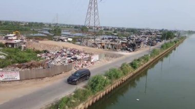 Jakarta, Indonesia in August 2022. An illegal garbage dump on the bank of the East Flood Canal. It causes pollution in the surrounding environment, pollution of air, soil and water in the vicinity.