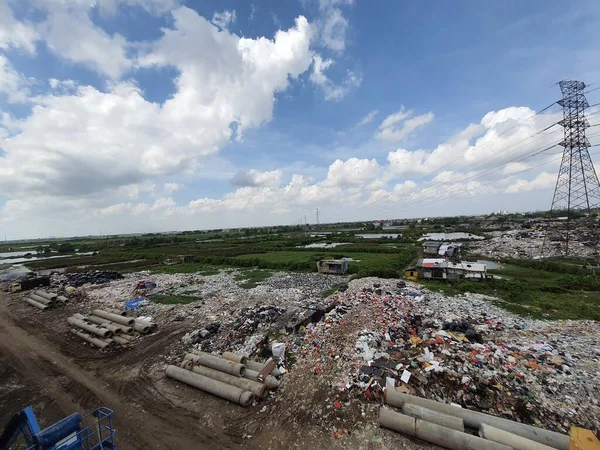 Jakarta, Indonesia in August 2022. An illegal garbage dump on the bank of the East Flood Canal. It causes pollution in the surrounding environment, pollution of air, soil and water in the vicinity.
