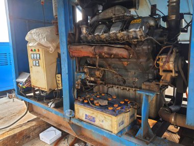 The inside of a generator, this generator is opened during operation to reduce heat when the engine is running. A generator set is a machine or device consisting of a power generator (generator) with a driving engine that is arranged into a single un