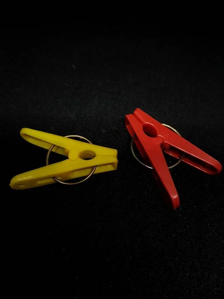 Isolated Photo Clothespins Red Yellow Very Contrasting Colors Black Background — Zdjęcie stockowe