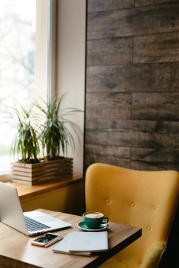 modern living room with table, laptop and cup of coffee