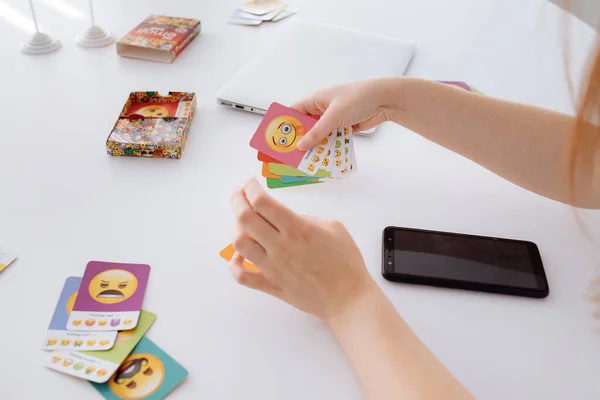 People playing board games at a white table