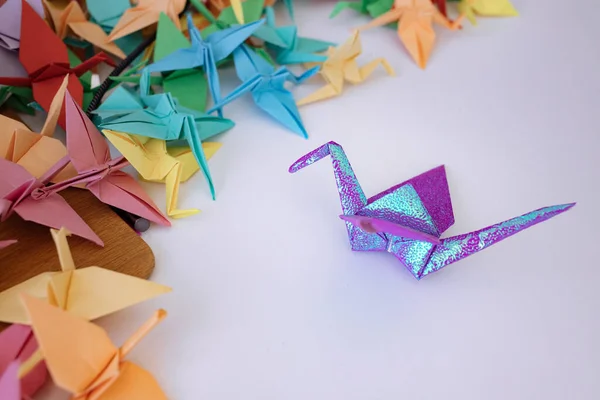 Colorful origami birds on the table