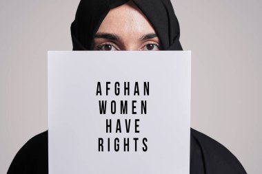 Muslim woman holding a paper with text - Afghan women have rights clipart
