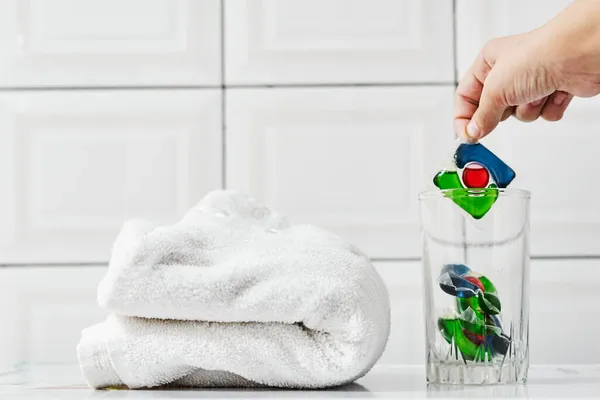 Toalla con cápsulas de lavandería y detergente — Foto de Stock