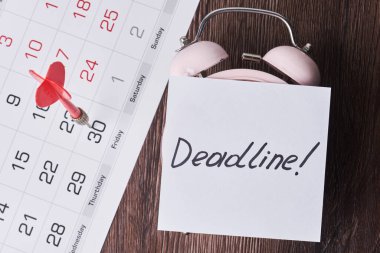 Kağıt, alarm saati ve aylık takvim üzerindeki son teslim tarihi