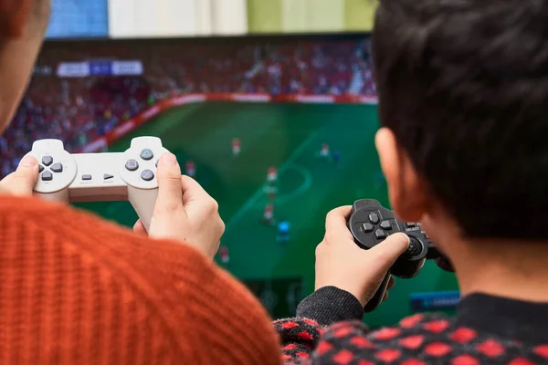 A little boy playing soccer on a gaming console — Stockfoto