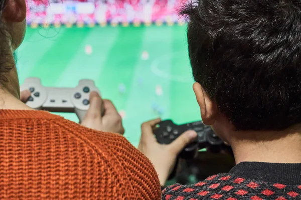 A little boy playing soccer on a gaming console — Stockfoto