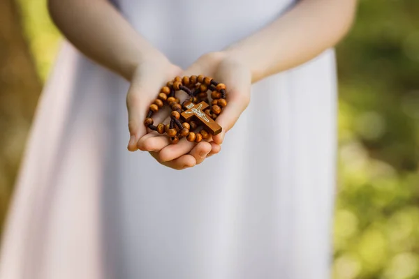 First Holy Communion. A child holding a rosary