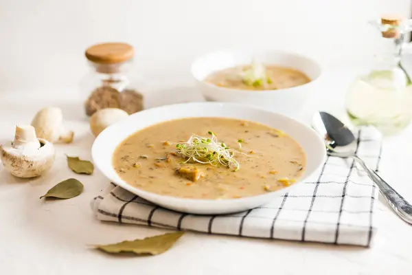 stock image Composition with mushroom soup in plate, fresh and dried mushrooms, on black table