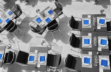 Empty outdoor terrace in a luxury restaurant, prepared with everything you need for lunch or dinner, even the ice bucket waiting for customers on the summer terrace.