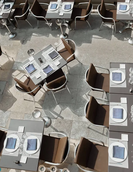 Empty outdoor terrace in a luxury restaurant, prepared with everything you need for lunch or dinner, even the ice bucket waiting for customers on the summer terrace.