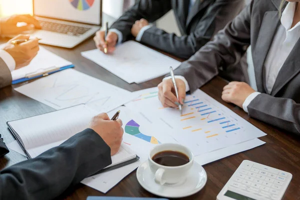 Group professional business people person working together to analyze in office, work together to discuss company financial statistics report, brainstorm ideas, and graph datum documents on the table.