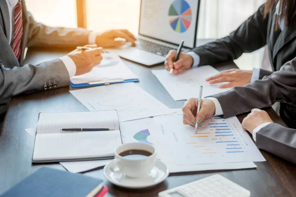 Group professional business people person working together to analyze in office, work together to discuss company financial statistics report, brainstorm ideas, and graph datum documents on the table.