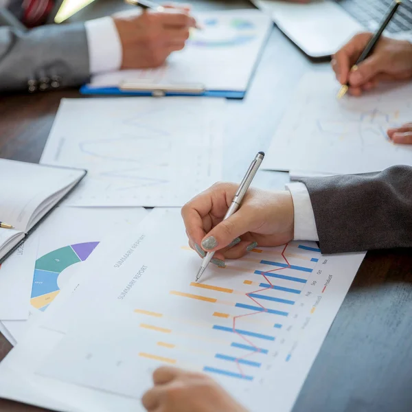 Group professional business people person working together to analyze in office, work together to discuss company financial statistics report, brainstorm ideas, and graph datum documents on the table.