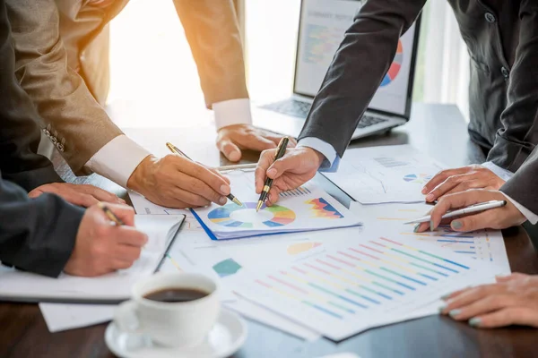 Group professional business people person working together to analyze in office, work together to discuss company financial statistics report, brainstorm ideas, and graph datum documents on the table.