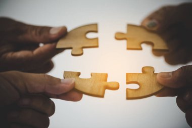Bir grup iş adamı yapboz yapıyor ve takım desteği ve konsepti temsil ediyor.