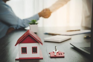 Estate agent shaking hands with client after contract signature and done business deal for transfer right of property. Man broker realtor real estate agent shake hands of happy clients homeowners