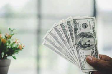  woman hand holding money for saving money wealth and financial concept.