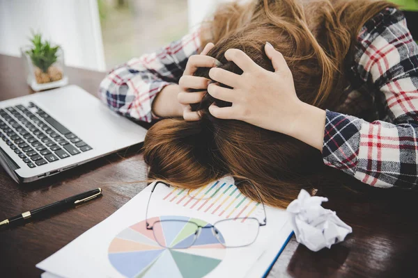 Young frustrated exhausted woman laid her head down on the table sit work at white desk with contemporary  laptop isolated. Achievement business career concept. Copy space