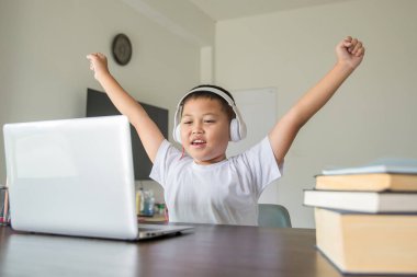 Young student distance learning virtual distance online class on video call virtual lesson, technology studying at home using laptop computer. Parent or tutor teaching child boy with remote education.