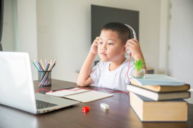 Young student distance learning virtual distance online class on video call virtual lesson, technology studying at home using laptop computer. Parent or tutor teaching child boy with remote education.