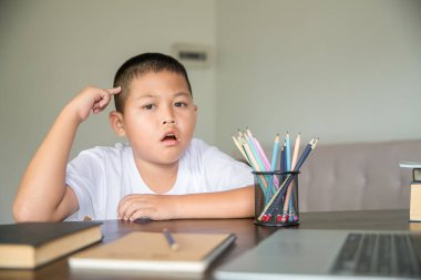 Young student distance learning virtual distance online class on video call virtual lesson, technology studying at home using laptop computer. Parent or tutor teaching child boy with remote education.