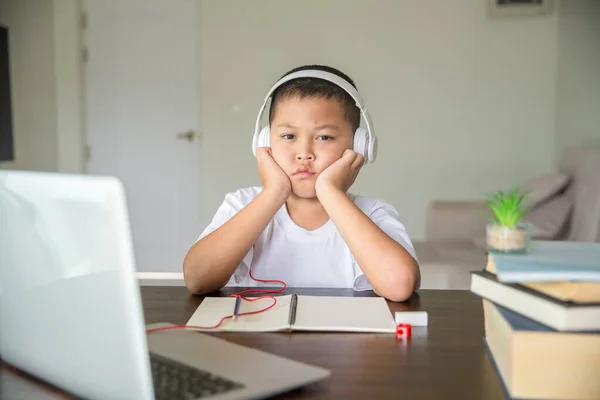 Young student distance learning virtual distance online class on video call virtual lesson, technology studying at home using laptop computer. Parent or tutor teaching child boy with remote education.