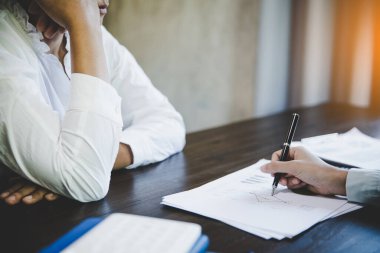 Business adviser analyzing financial figures denoting the progress in the work of the company Design Ideas Concept. 