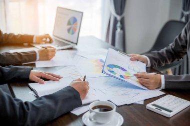 Group professional business people person working together to analyze in office, work together to discuss company financial statistics report, brainstorm ideas, and graph datum documents on the table.