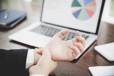 young asian business woman wrist pain from using computer.Health problems concept